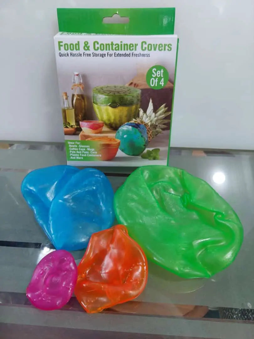 Colorful food container covers with packaging on a reflective surface