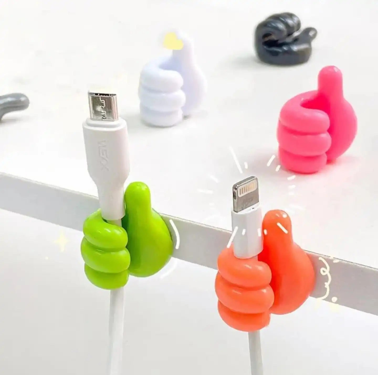 Colorful cable tie holders on USB cables against a white background