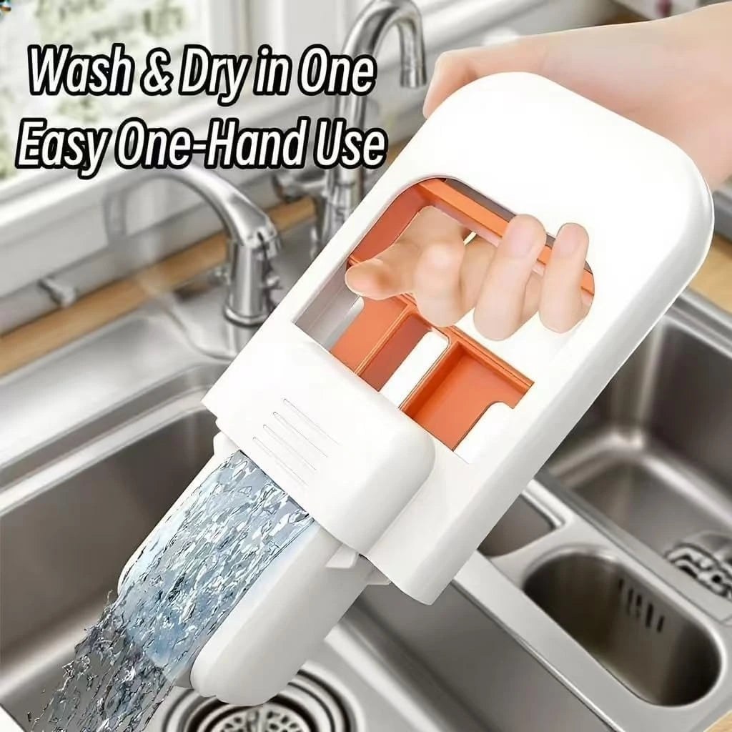 Handheld device with water flowing over it, used for washing and drying, in a kitchen sink setting.
