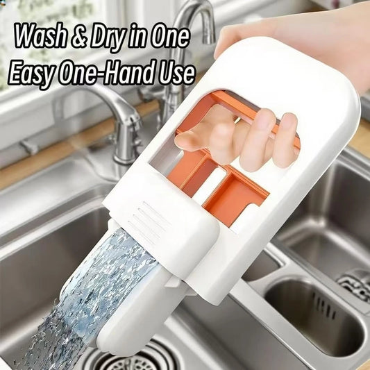 Handheld device with water flowing over it, used for washing and drying, in a kitchen sink setting.