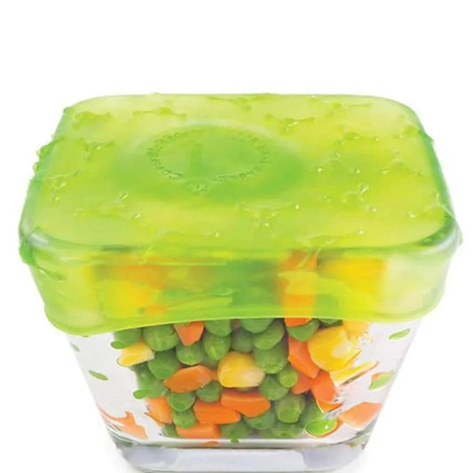 A square clear glass food storage container with a translucent bright green lid, shown filled with mixed vegetables including peas, carrots, and corn on a white background.
