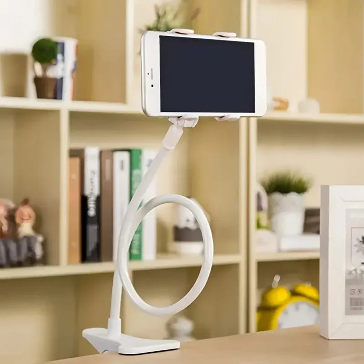 White phone holder on a desk with a blurred background of shelves and decor items