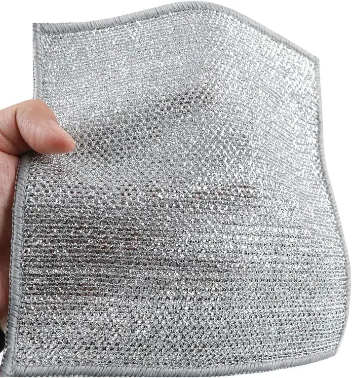 Hand holding a textured silver fabric sample