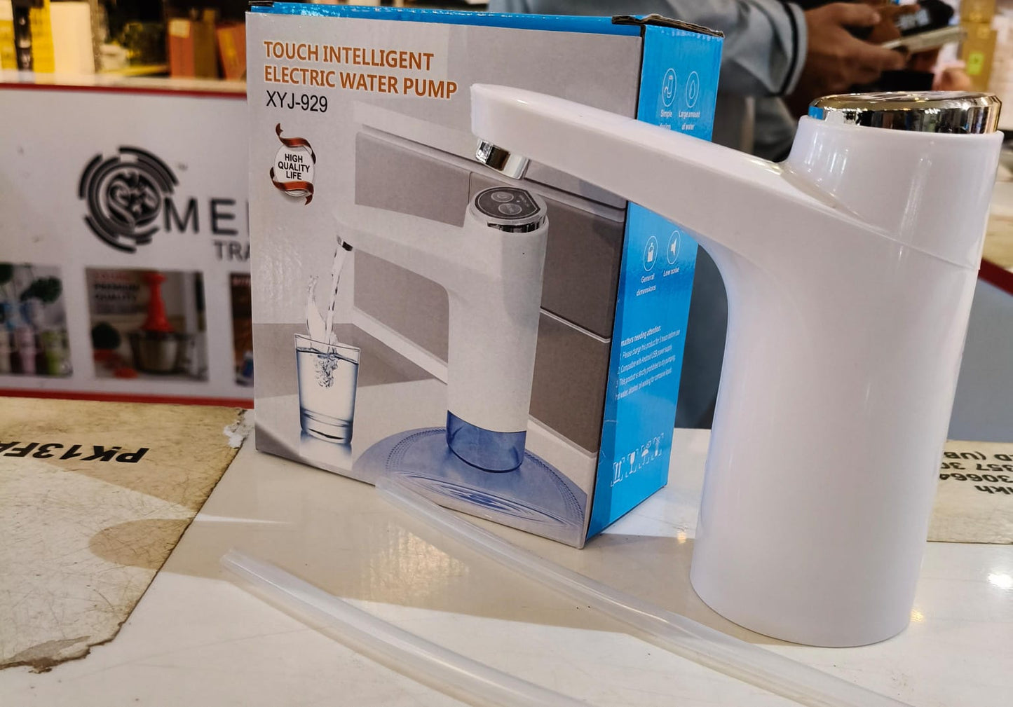 White electric water pump with packaging on a table