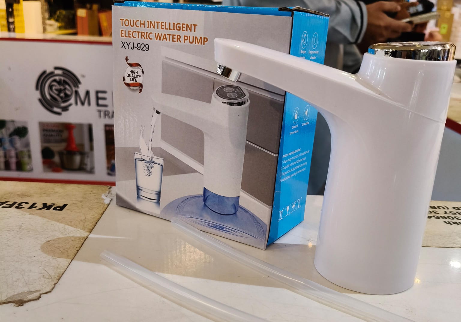White electric water pump with packaging on a table