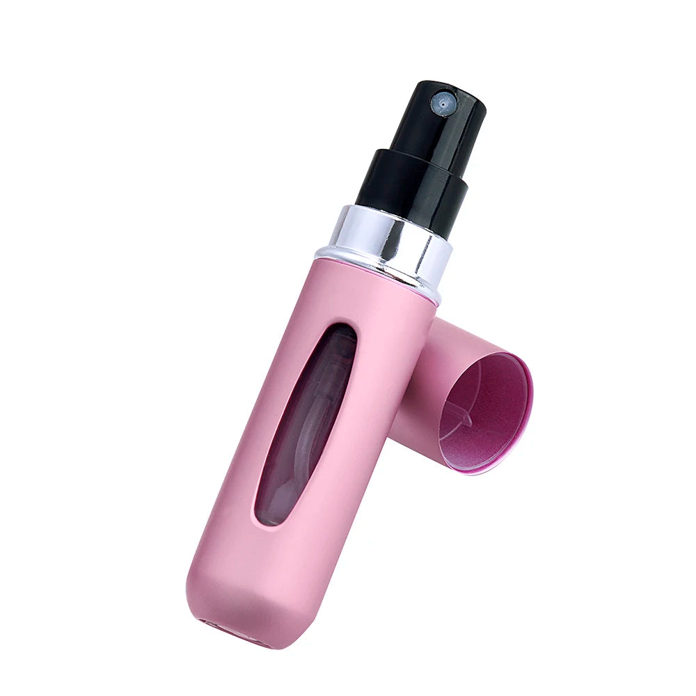 Pink spray bottle with black nozzle on a white background
