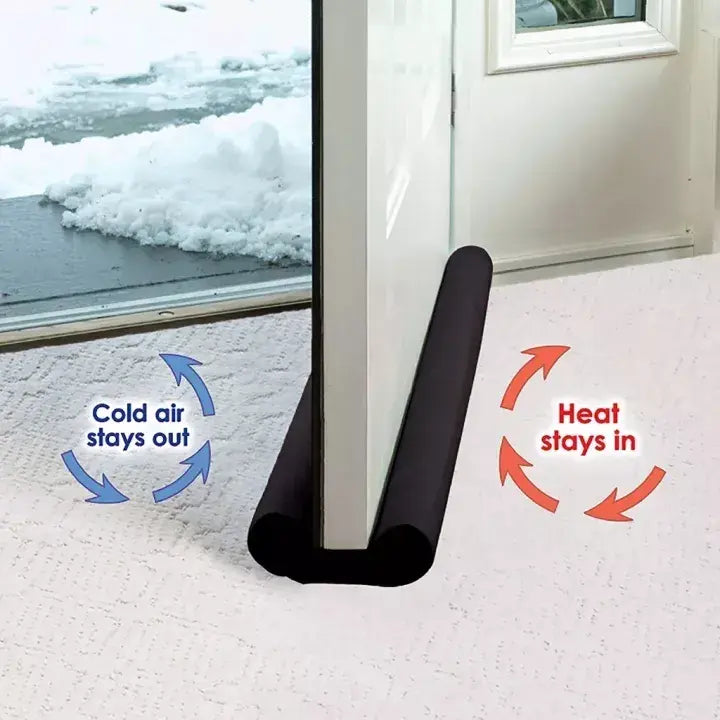 Black weather stripping under a door with arrows indicating airflow direction.
