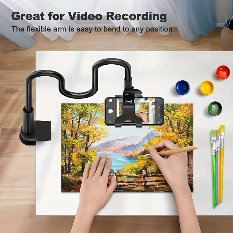 Flexible arm for video recording with smartphone and painting setup on a table.