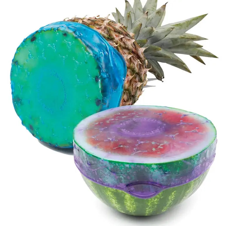 Colorful pineapple and watermelon-shaped bath bombs on a white background
