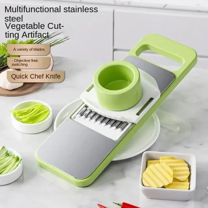 Multifunctional stainless steel vegetable cutting artifact with green and gray design on a kitchen counter.
